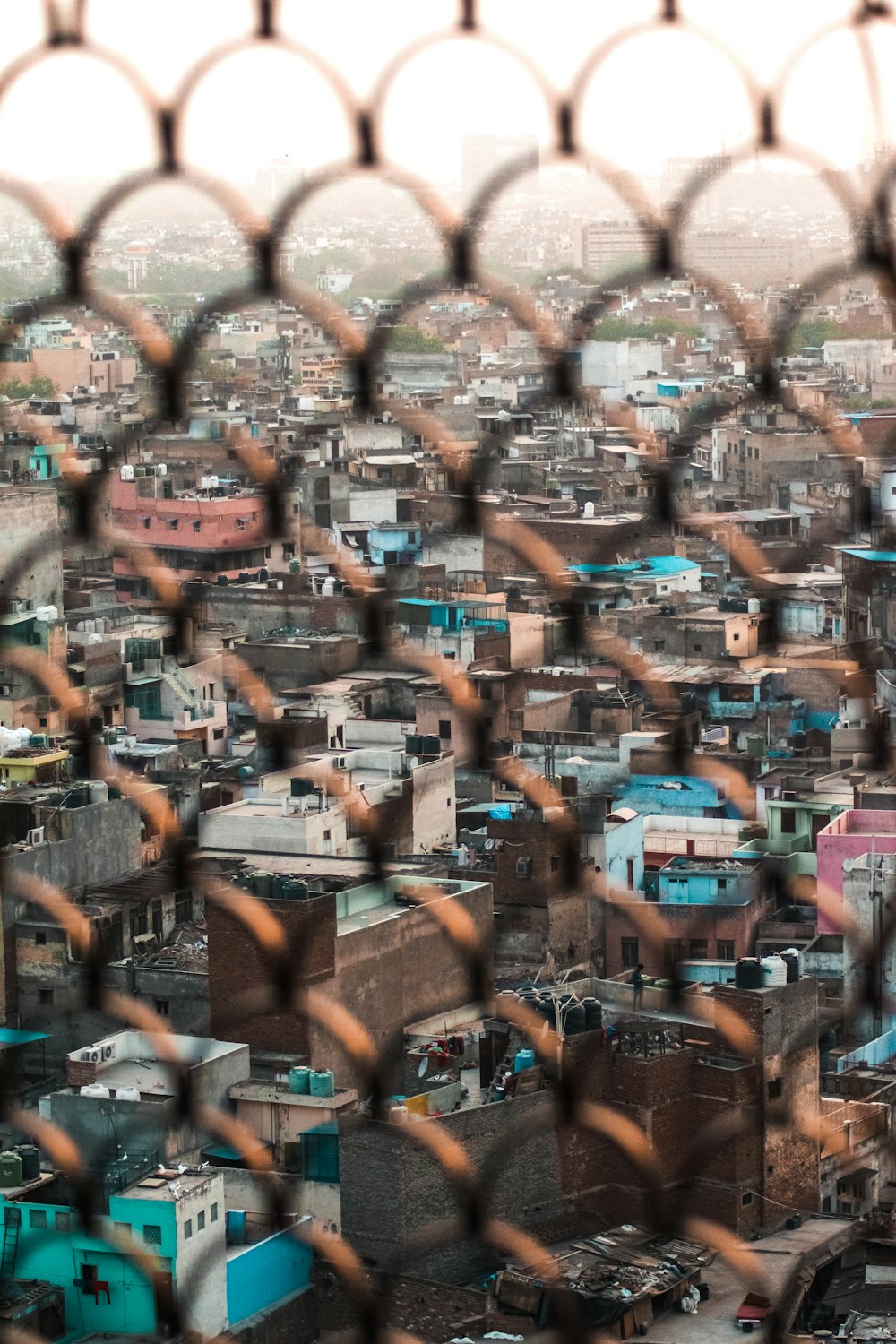 brown and black metal fence with brown cardboard boxes