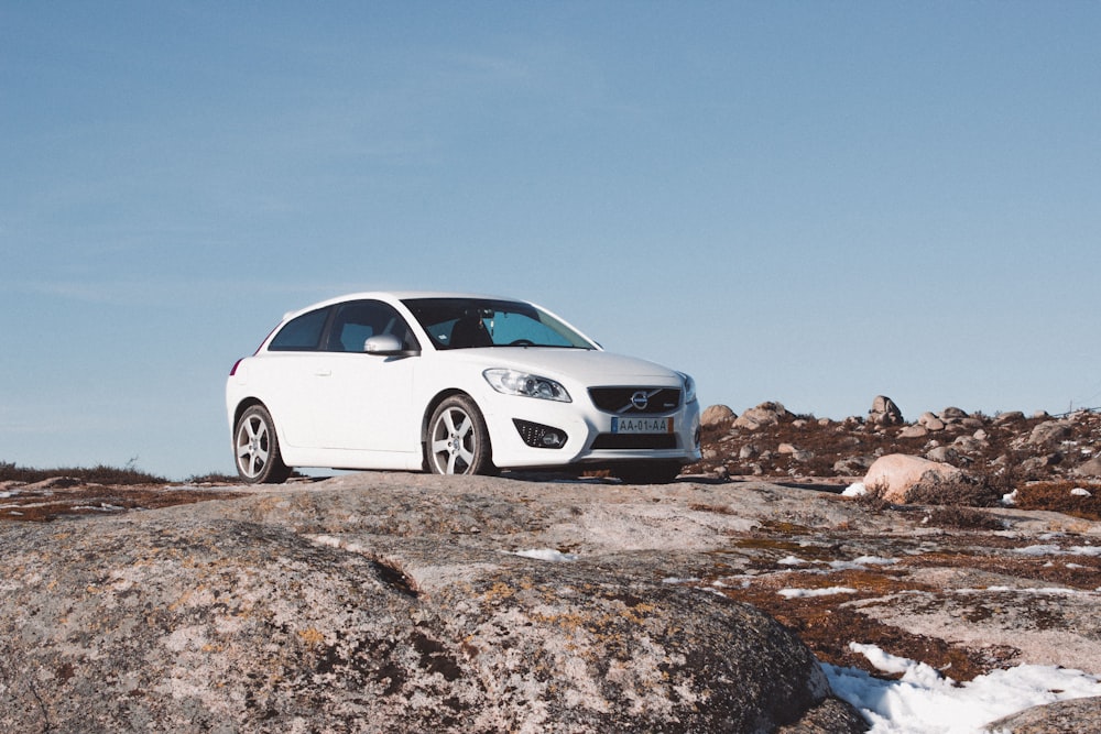 white bmw m 3 coupe on gray rocky ground under blue sky during daytime