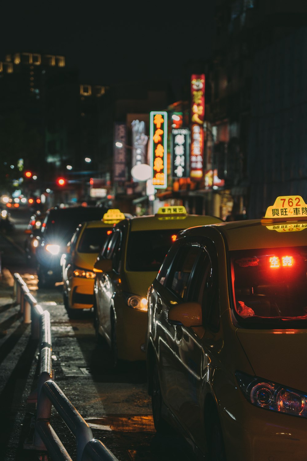 black and yellow taxi cab on road during night time