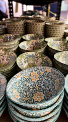 A colorful collection of hand-thrown stoneware bowls stacked gently, showcasing varied glazes.