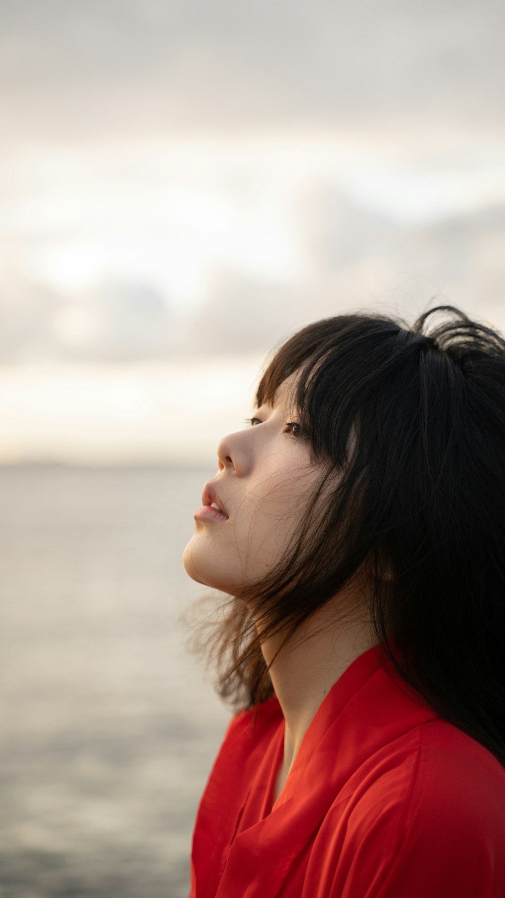 woman in red shirt looking down