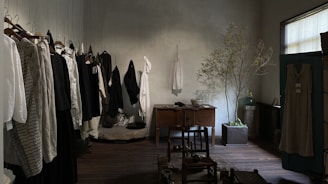 A cozy corner with soft natural light, featuring simple clothing pieces inspired by Korean minimalism