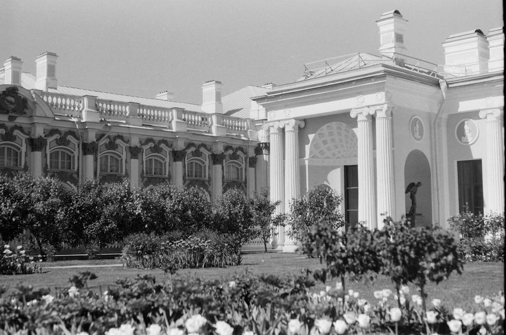 grayscale photo of people in front of building