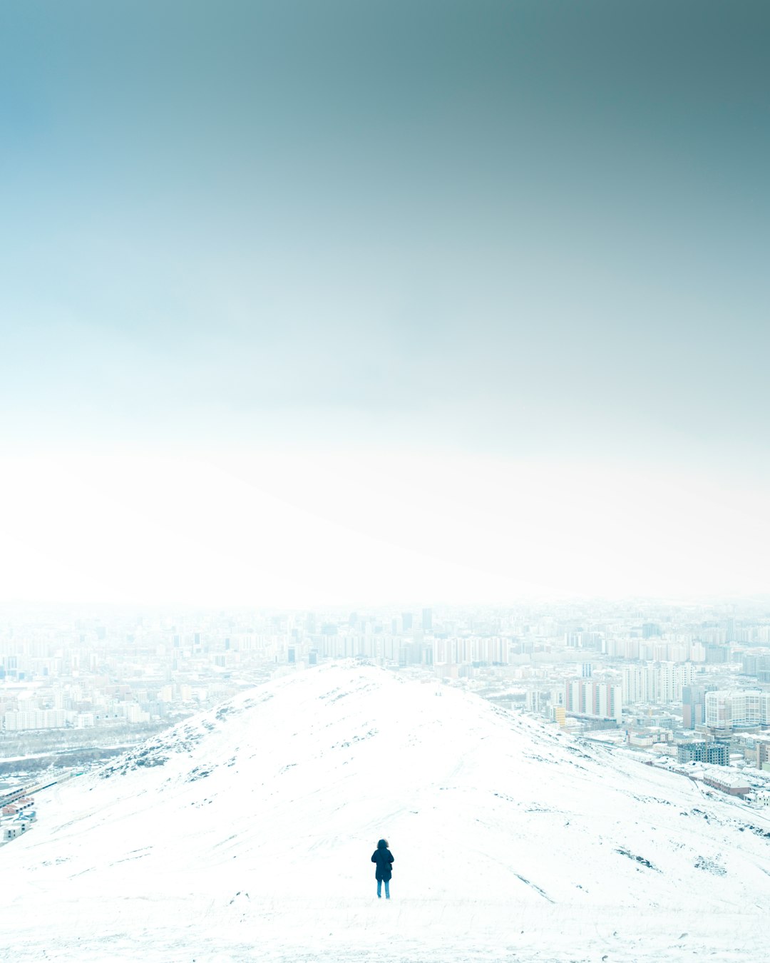 snow covered mountain under gray sky