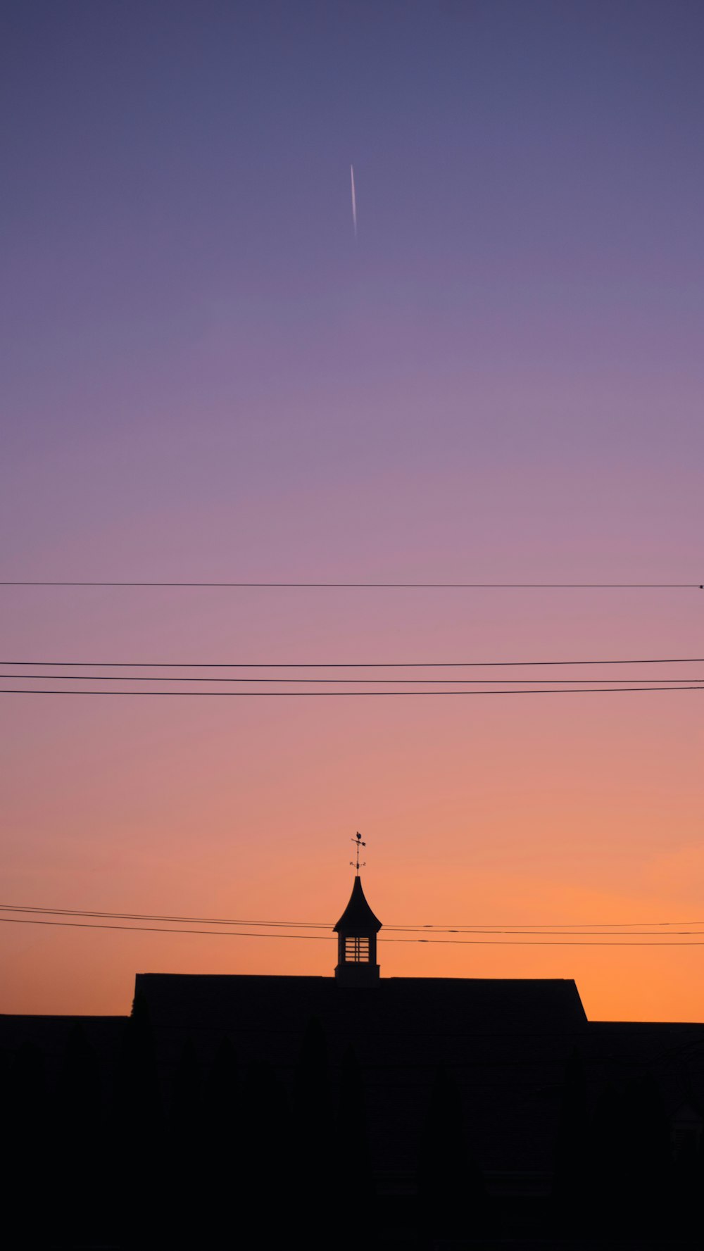 silhouette of building under blue sky during daytime