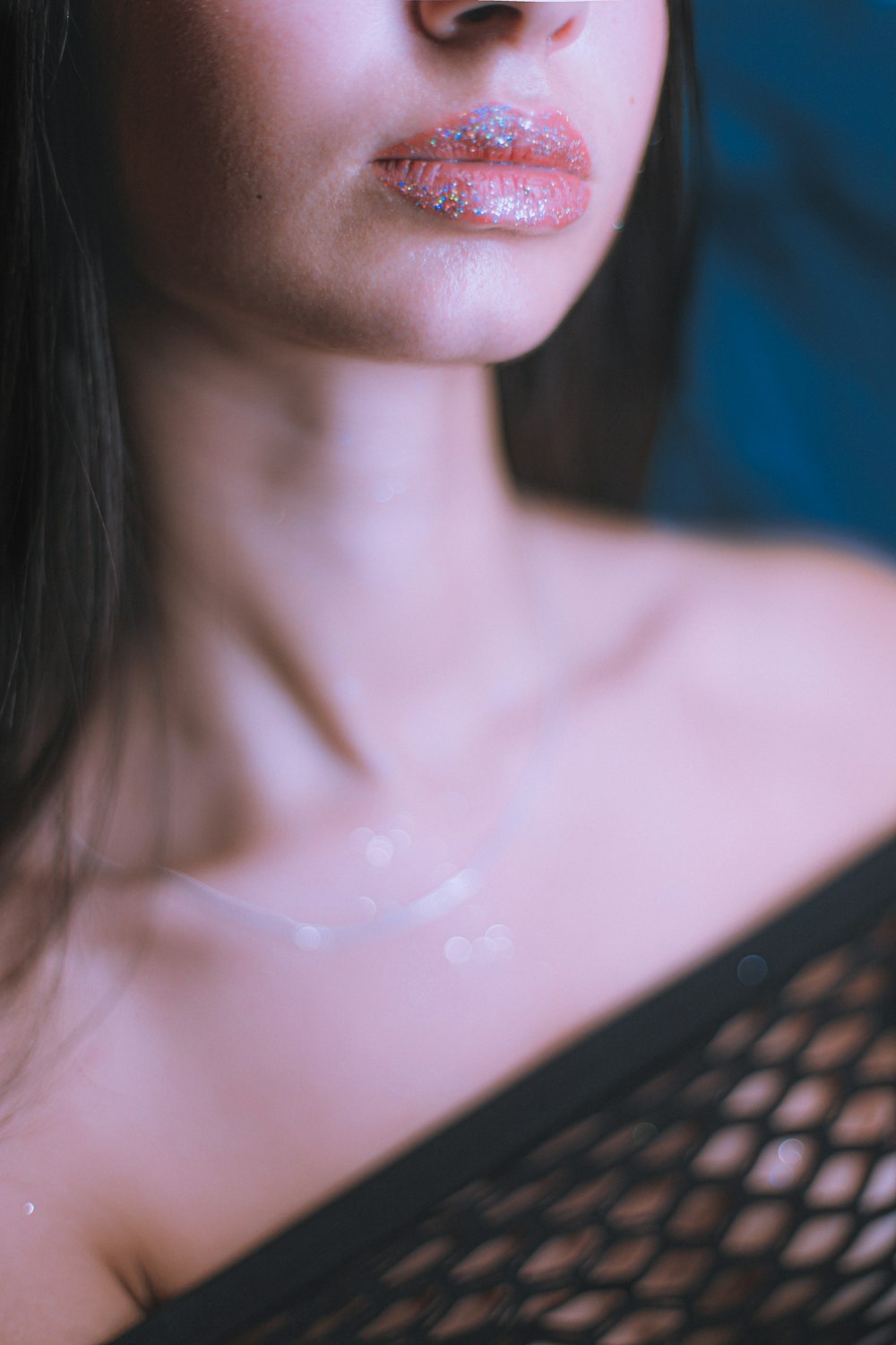 topless woman with silver necklace