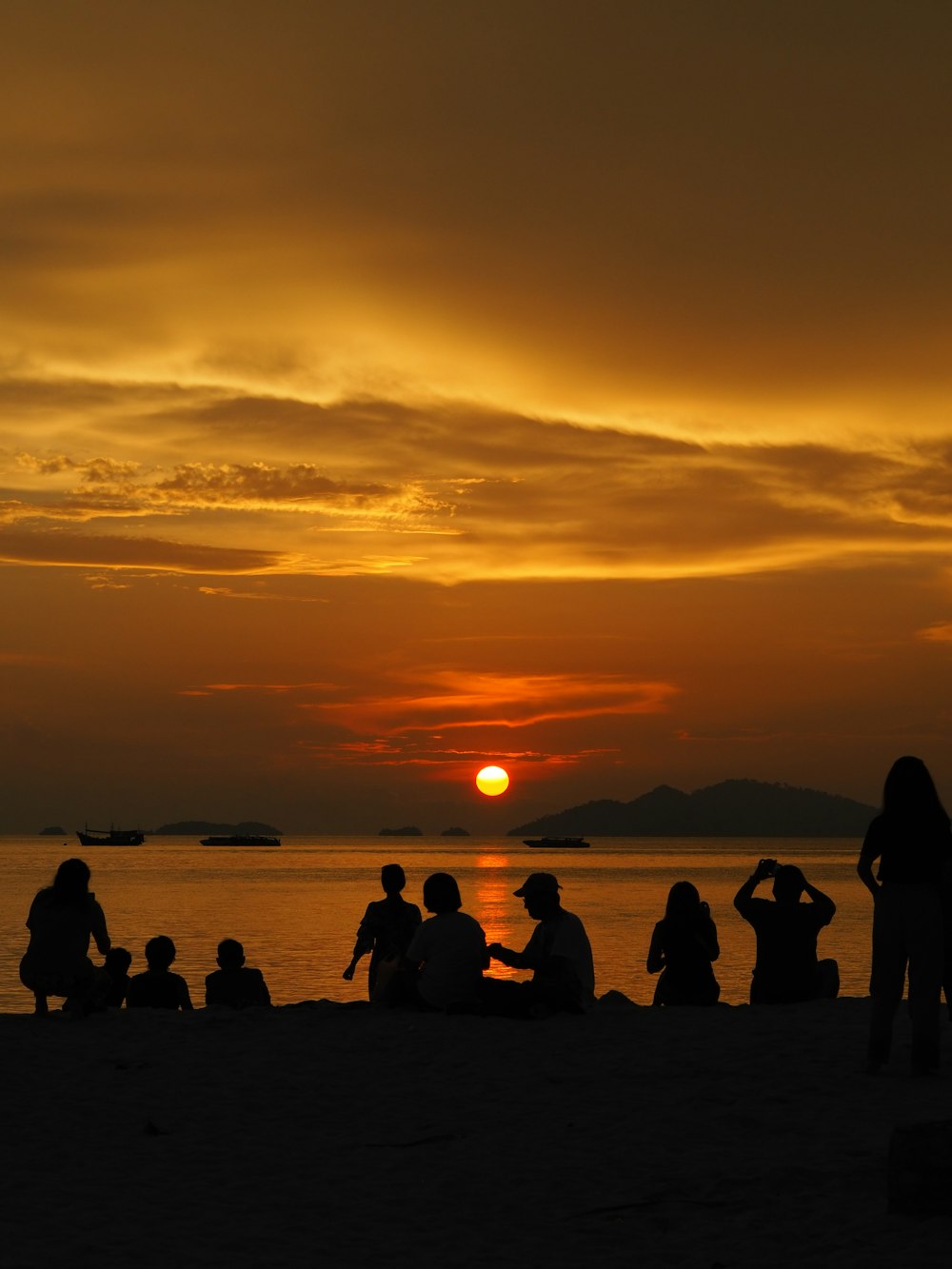 silhouette of people on beach during sunset