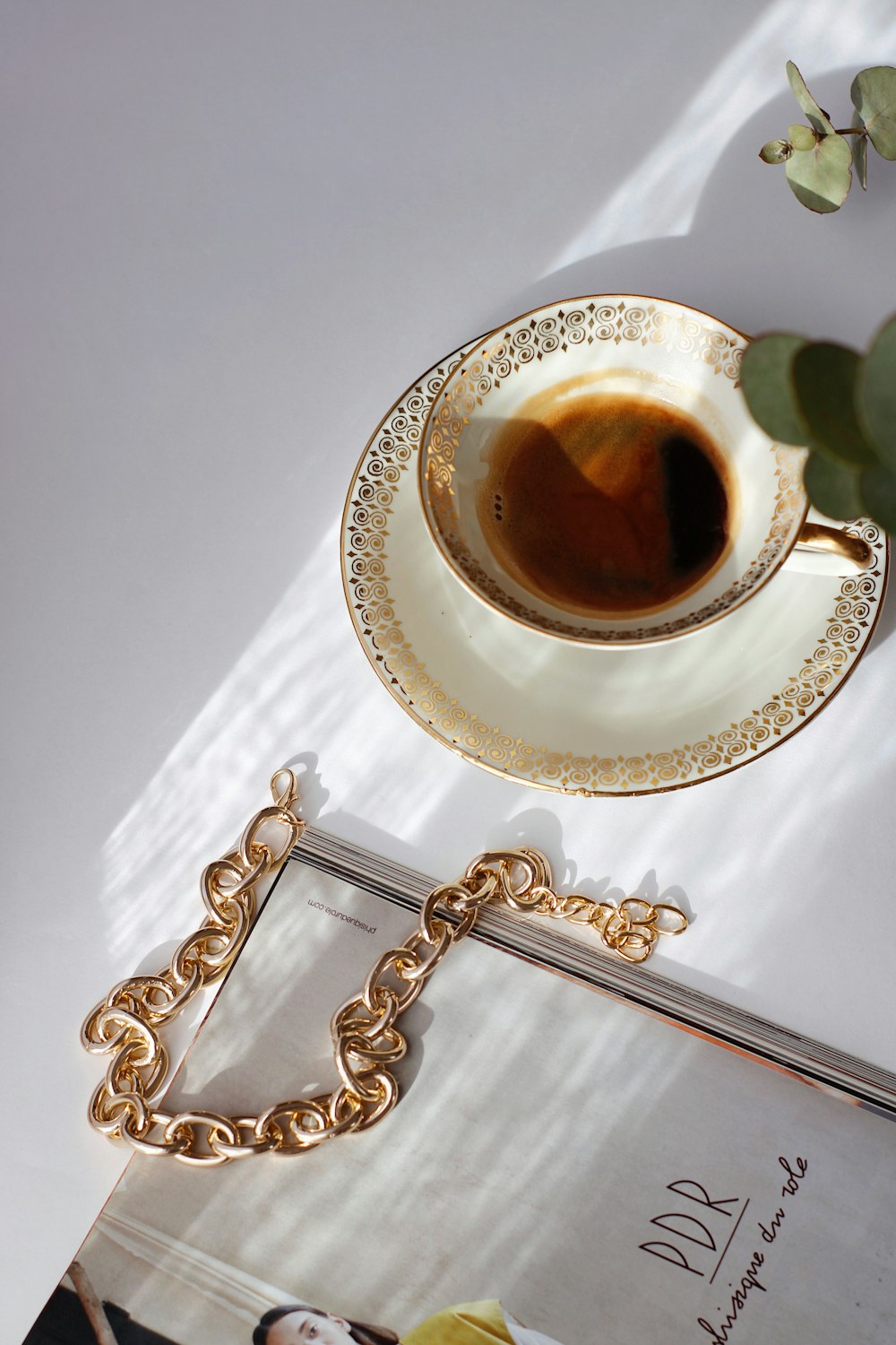 white ceramic cup on white saucer