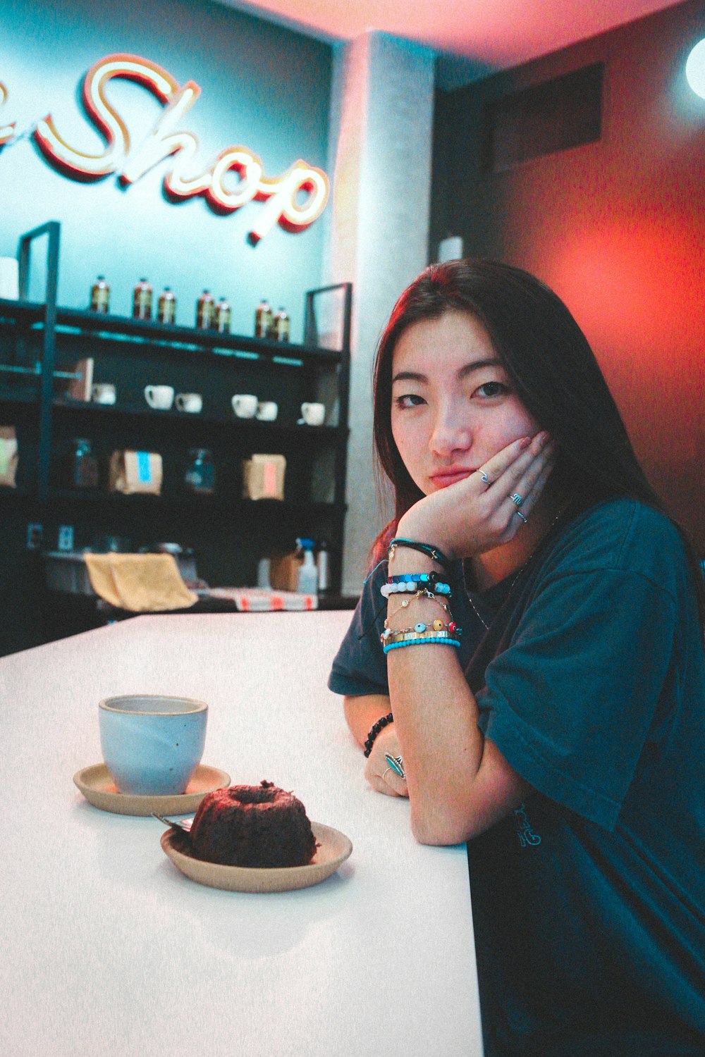 woman in green shirt sitting by the table