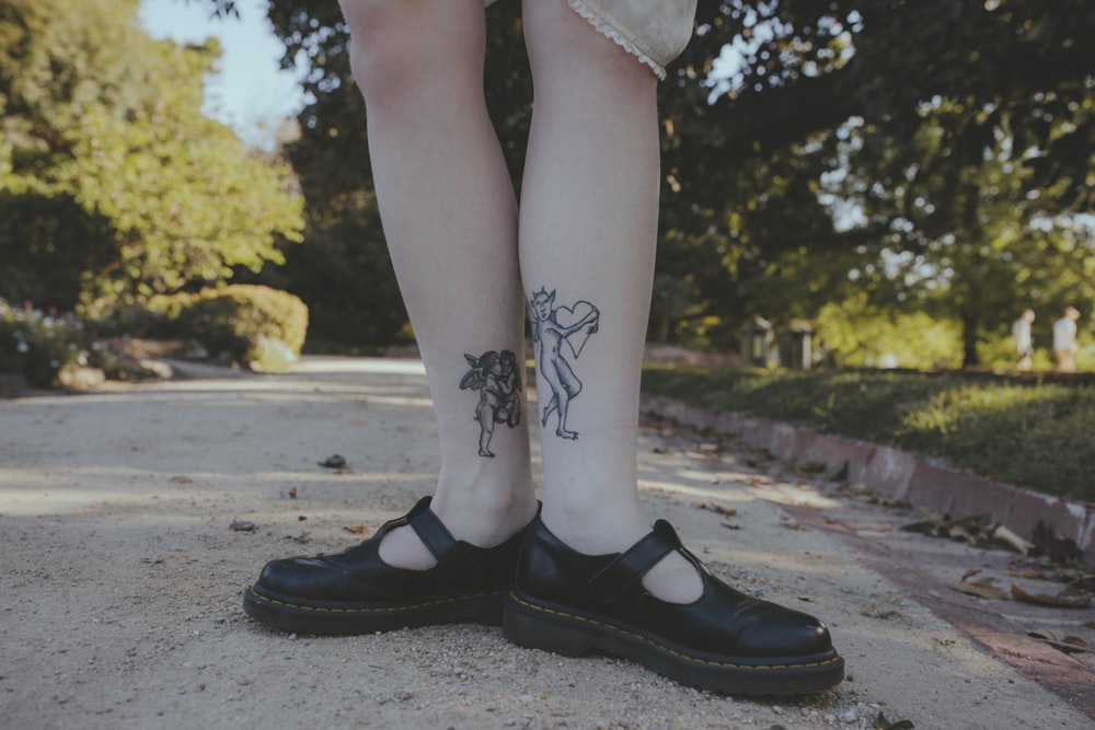 woman with black floral tattoo on her leg