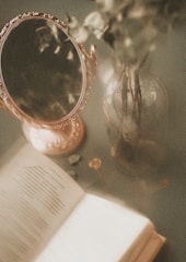 a mirror and a book on a table