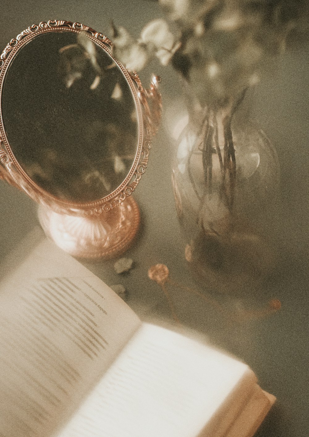 a mirror and a book on a table