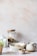 A serene image of a person enjoying a healthy meal in a bright, minimalistic kitchen.