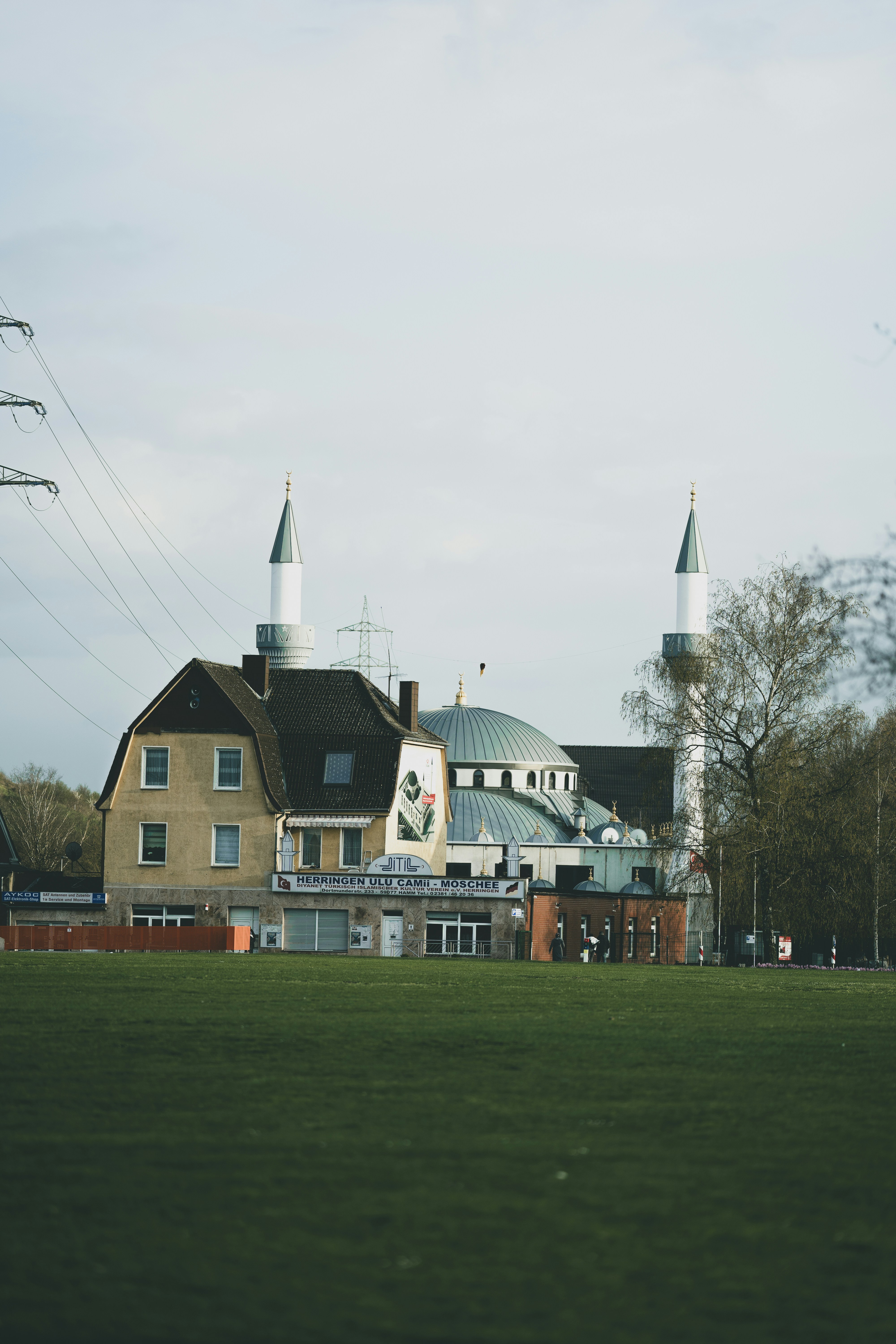 brown and white concrete building near green grass field during daytime