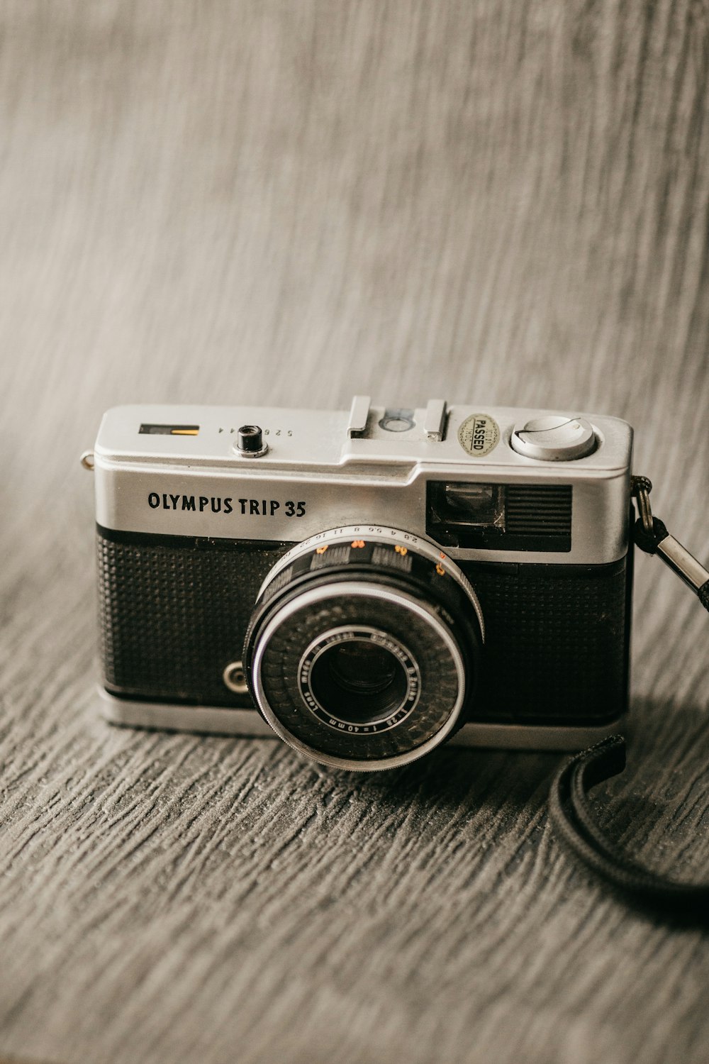 black and silver dslr camera on brown wooden table