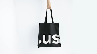 A vibrant red tote bag featuring a minimalist outline of the New Jersey state.