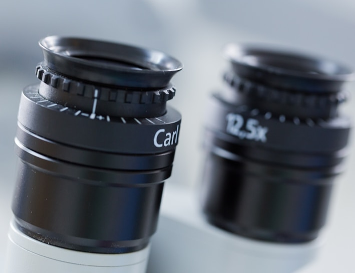 black camera lens on white table