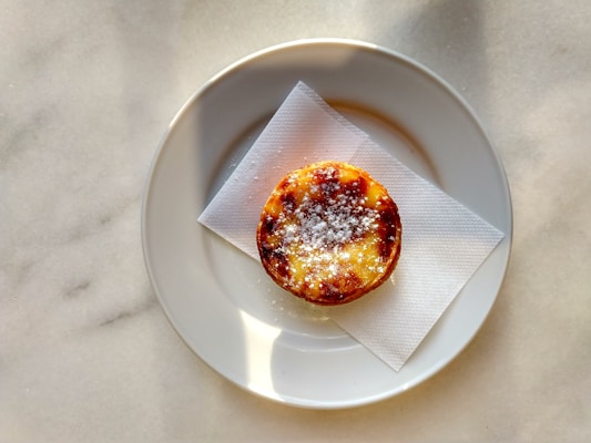 brown and white pastry on white round plate