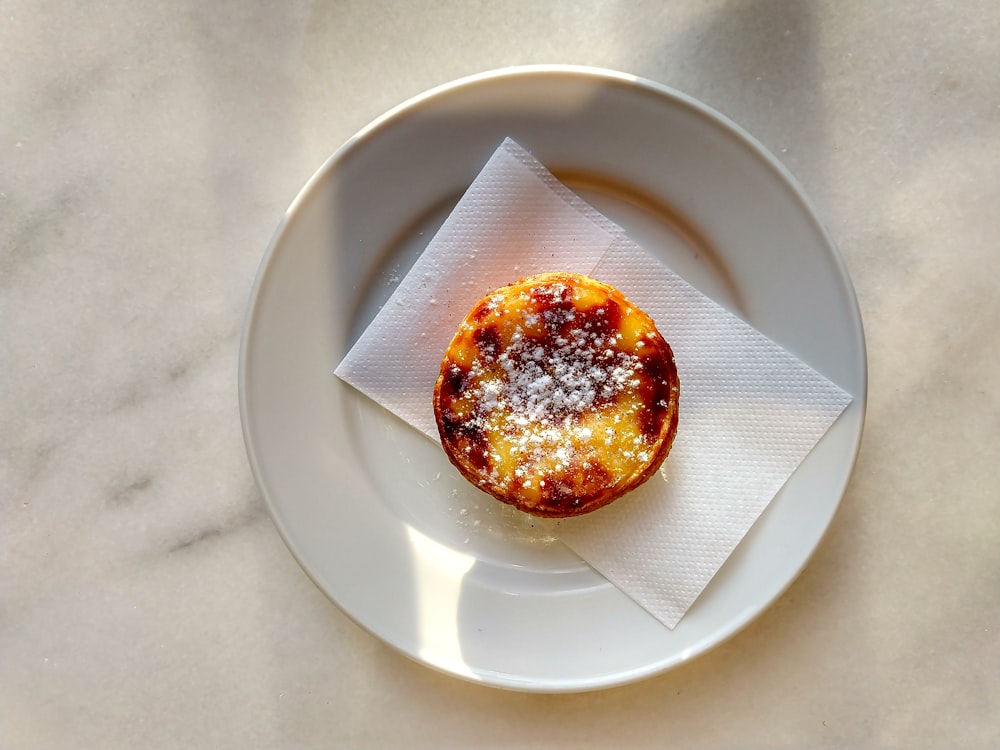 brown and white pastry on white round plate