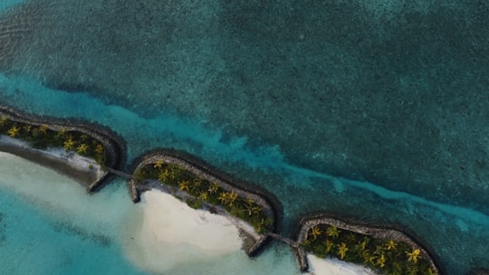 aerial view of green and white body of water in Malé Maldives