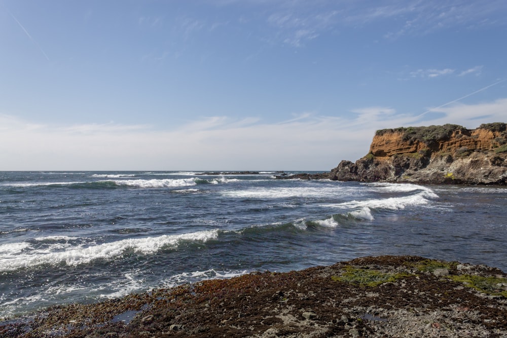 brown rock formation near sea during daytime