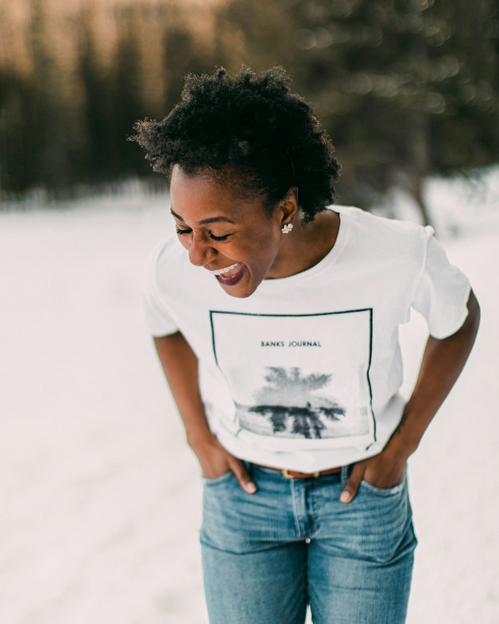 woman in white crew neck t-shirt and blue denim jeans