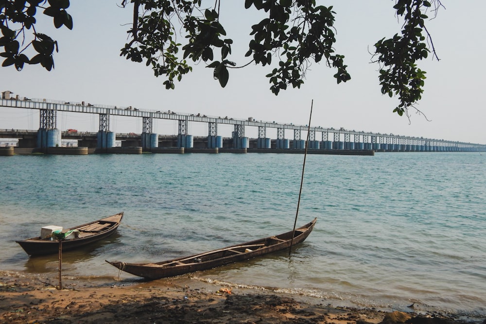 brown boat on shore during daytime