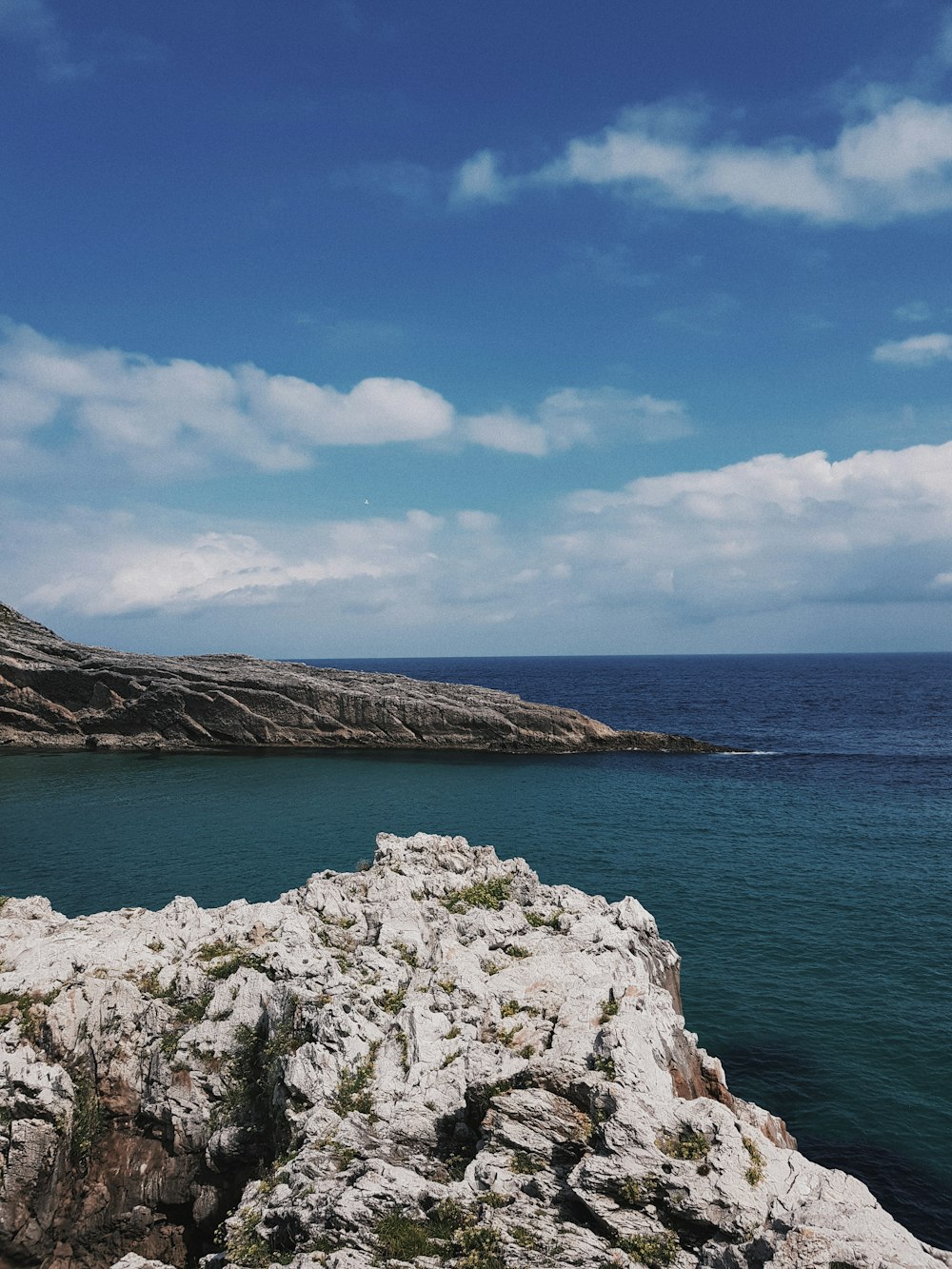 brown rock formation near body of water during daytime