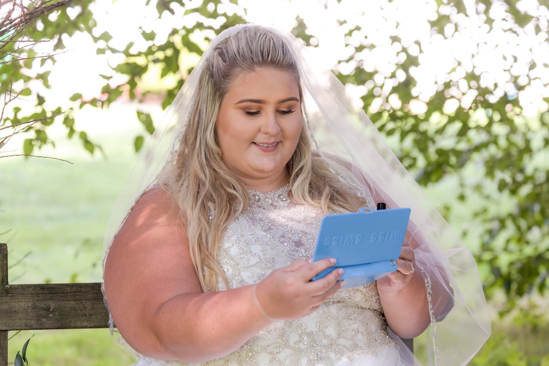 smiling woman holding blue tablet computer