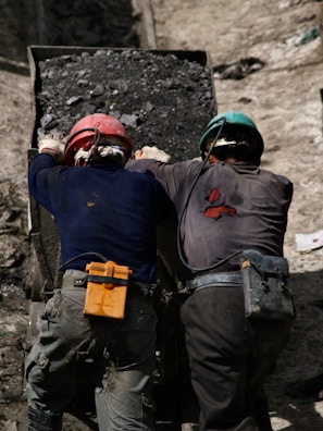 2 men in blue jacket wearing helmet