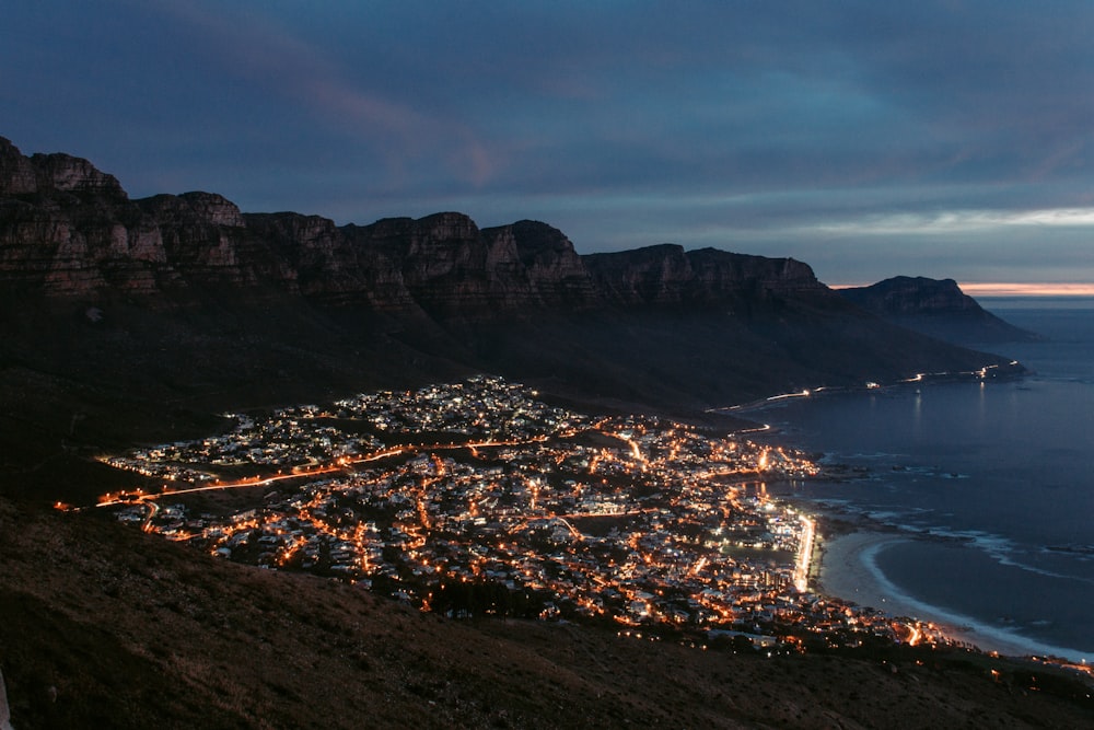 city near mountain during night time