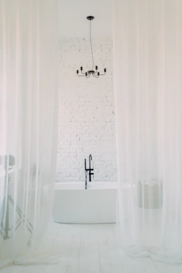 Bathroom with minimalist design, black fixtures, and subtle mood lighting.