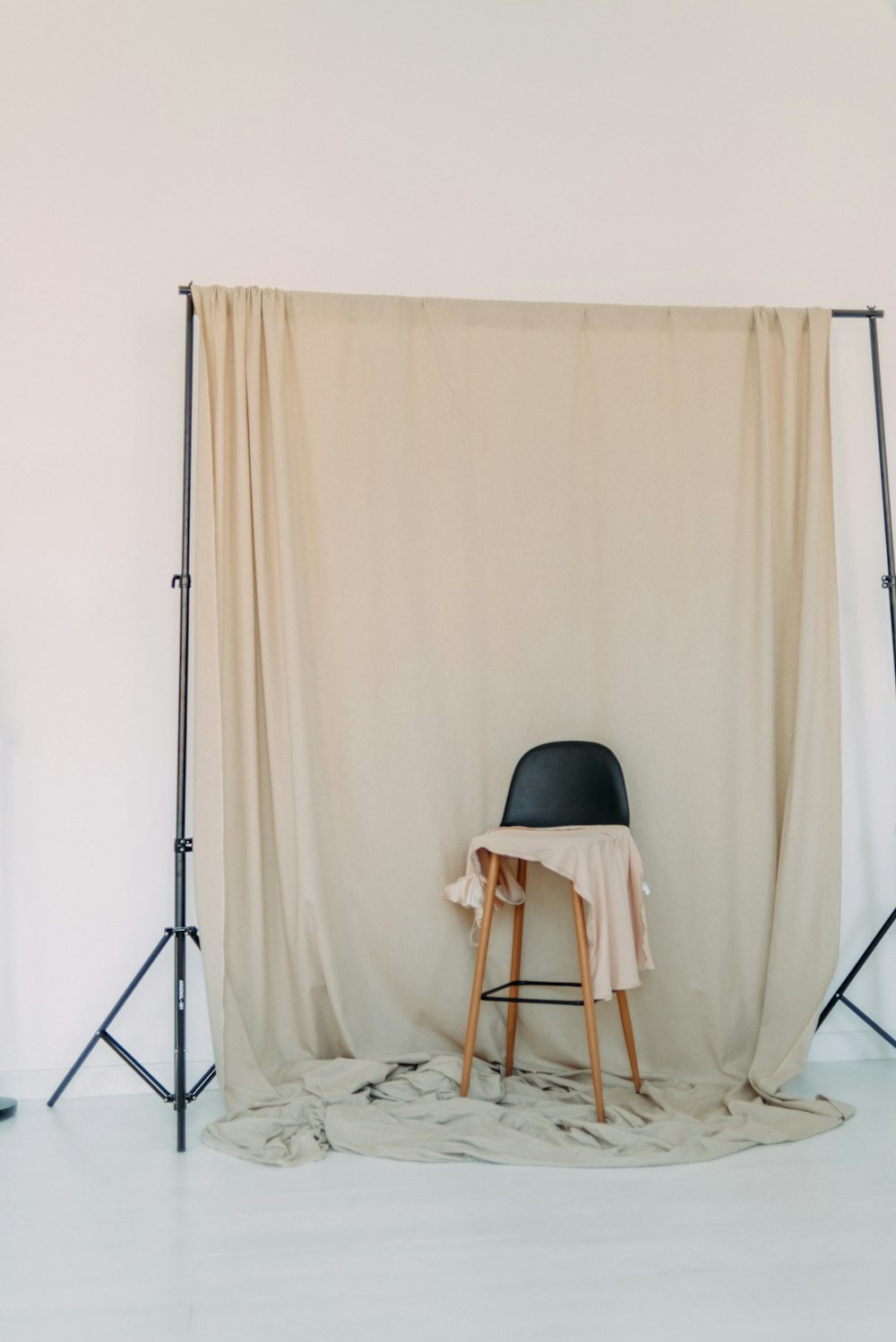 white wooden chair beside white curtain
