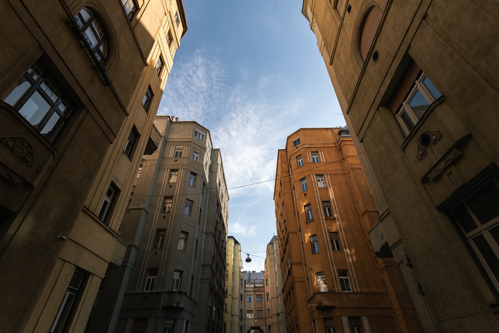 low angle photography of brown concrete building under blue sky during daytime