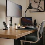 black flat screen computer monitor on brown wooden table