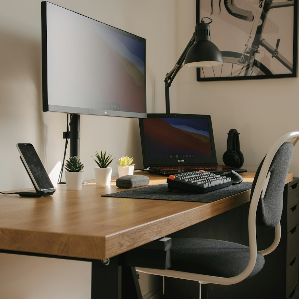 black flat screen computer monitor on brown wooden table