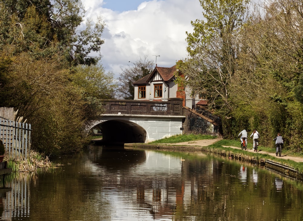 people walking on bridge over river during daytime