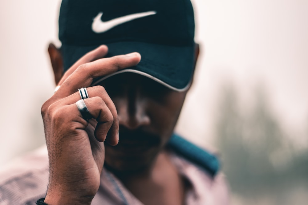 man in black nike fitted cap