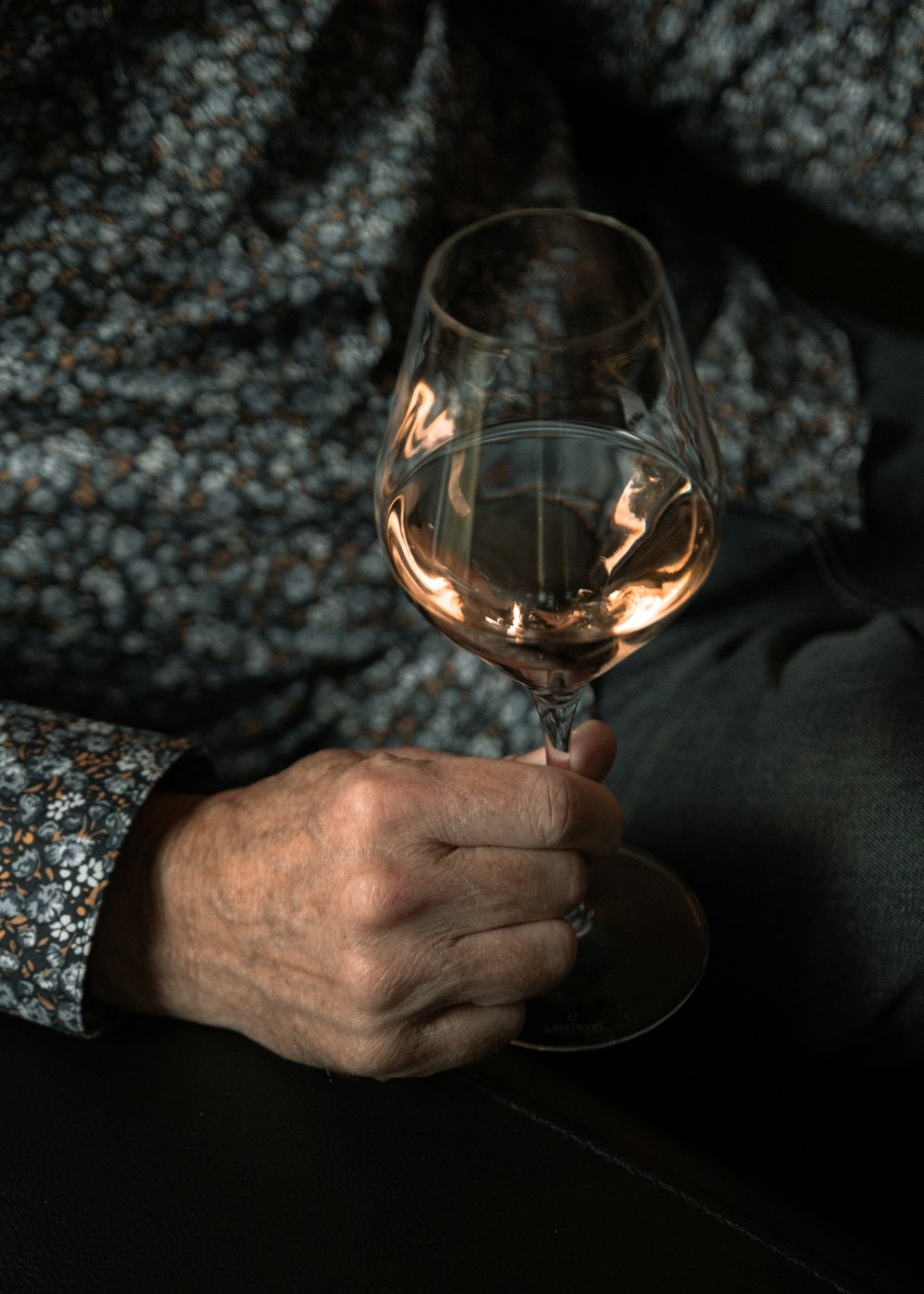 person holding clear wine glass