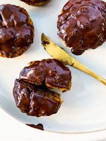 Close-up of the traditional trio of golden beignets with dipping sauces of caramel, dark chocolate fudge, and Nutella ganache.