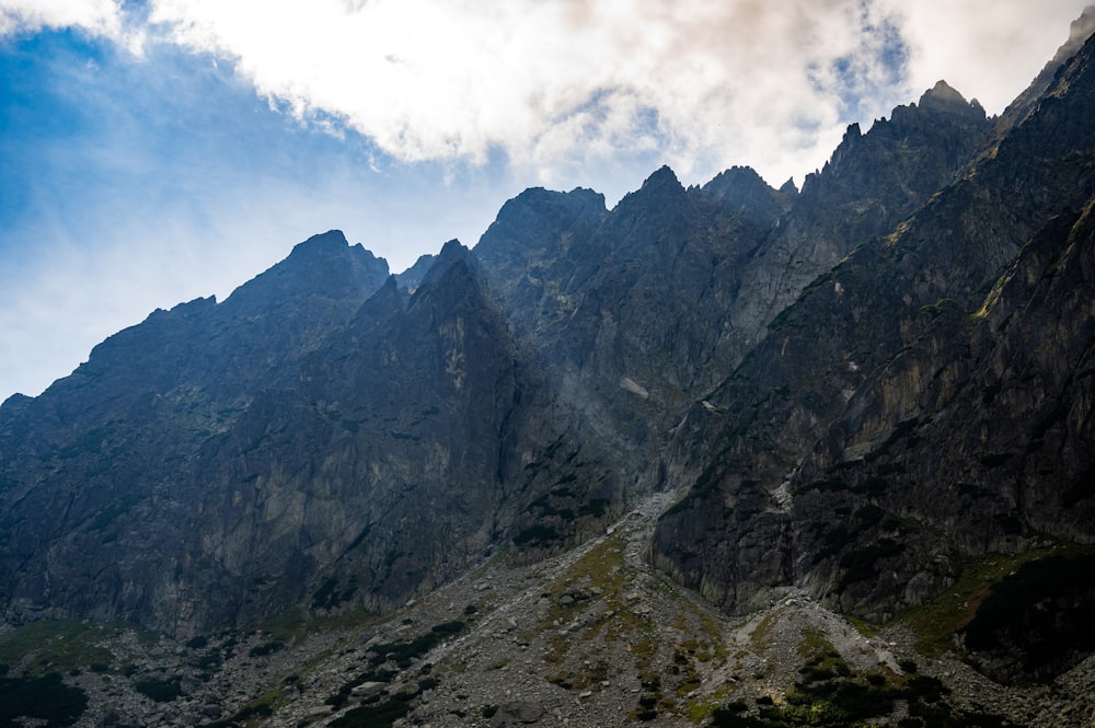 gray rocky mountain under white cloudy sky during daytime