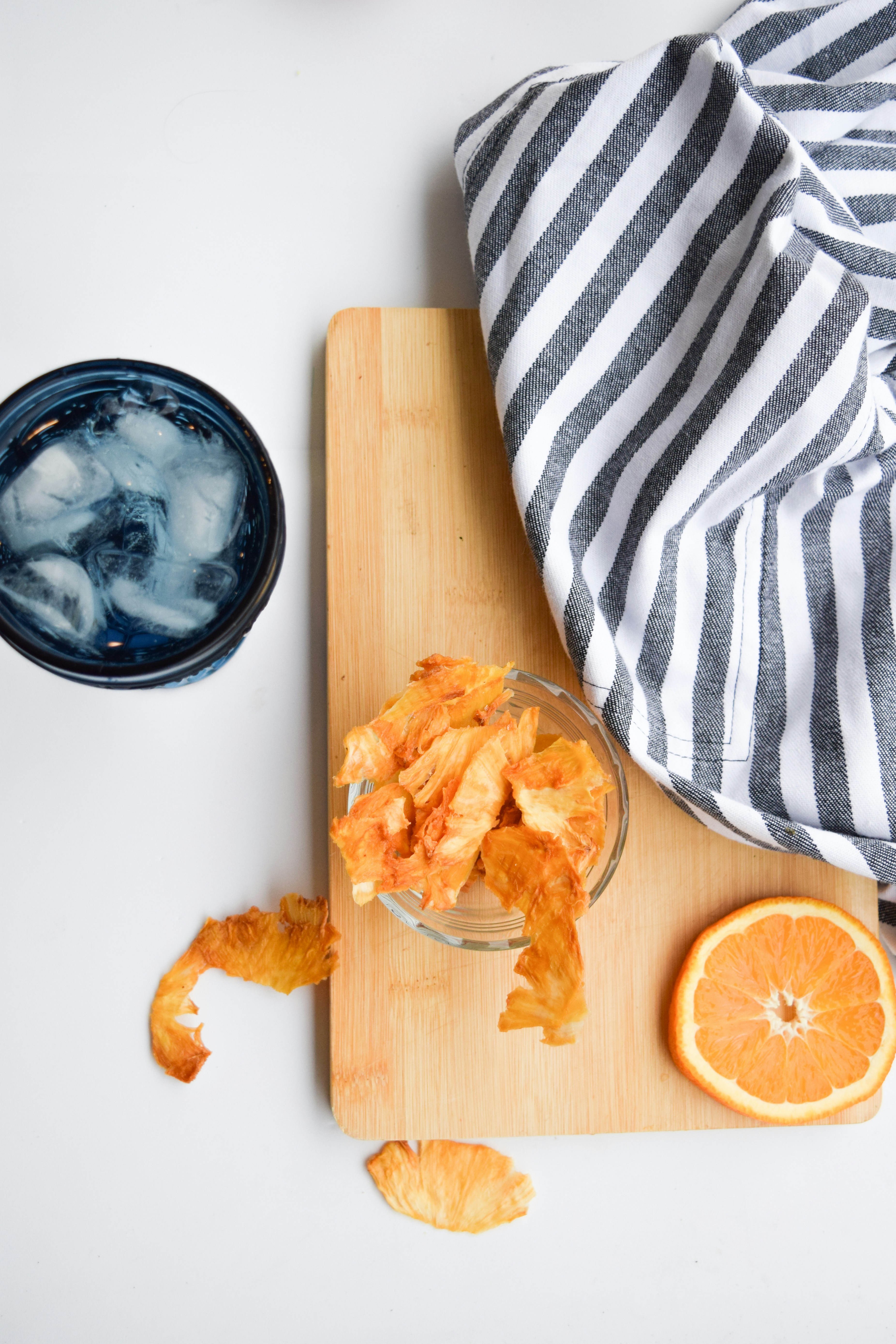 sliced orange fruit beside blue and white ceramic bowl