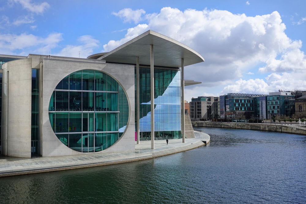 white and blue concrete building near body of water during daytime