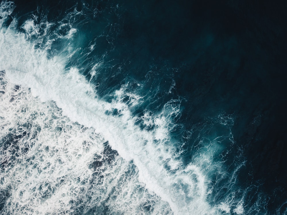 ocean waves crashing on shore during daytime