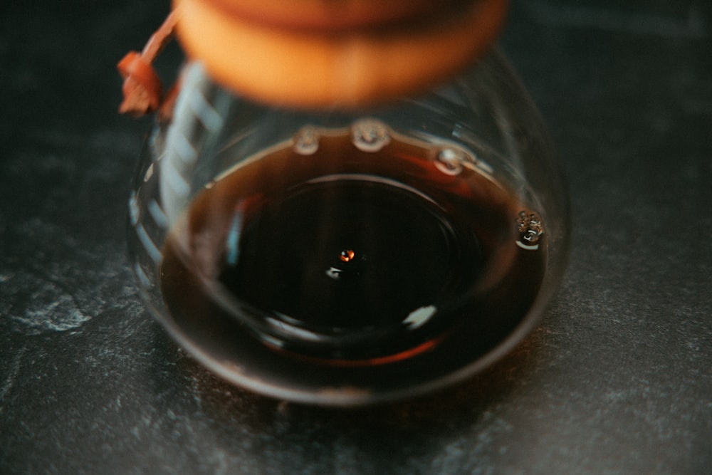 clear glass jar with brown liquid