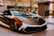 A sleek car with a bright, eye-catching custom wrap parked on a city street.