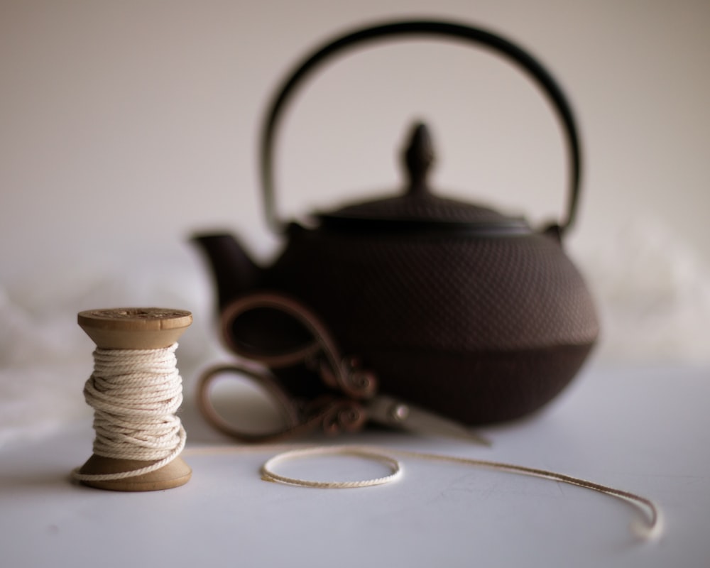 black teapot on white table
