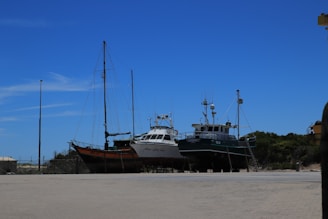 A dry dock facility with multiple yachts being serviced simultaneously.
