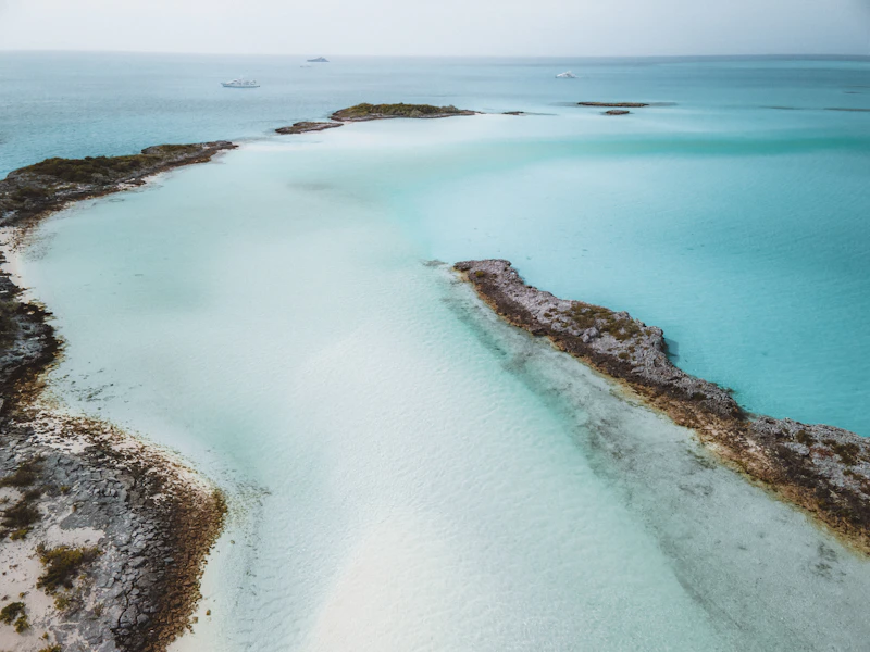 Pale sand and turquoise shallows at the mouth of a creek on Shroud Cay in the Exumas