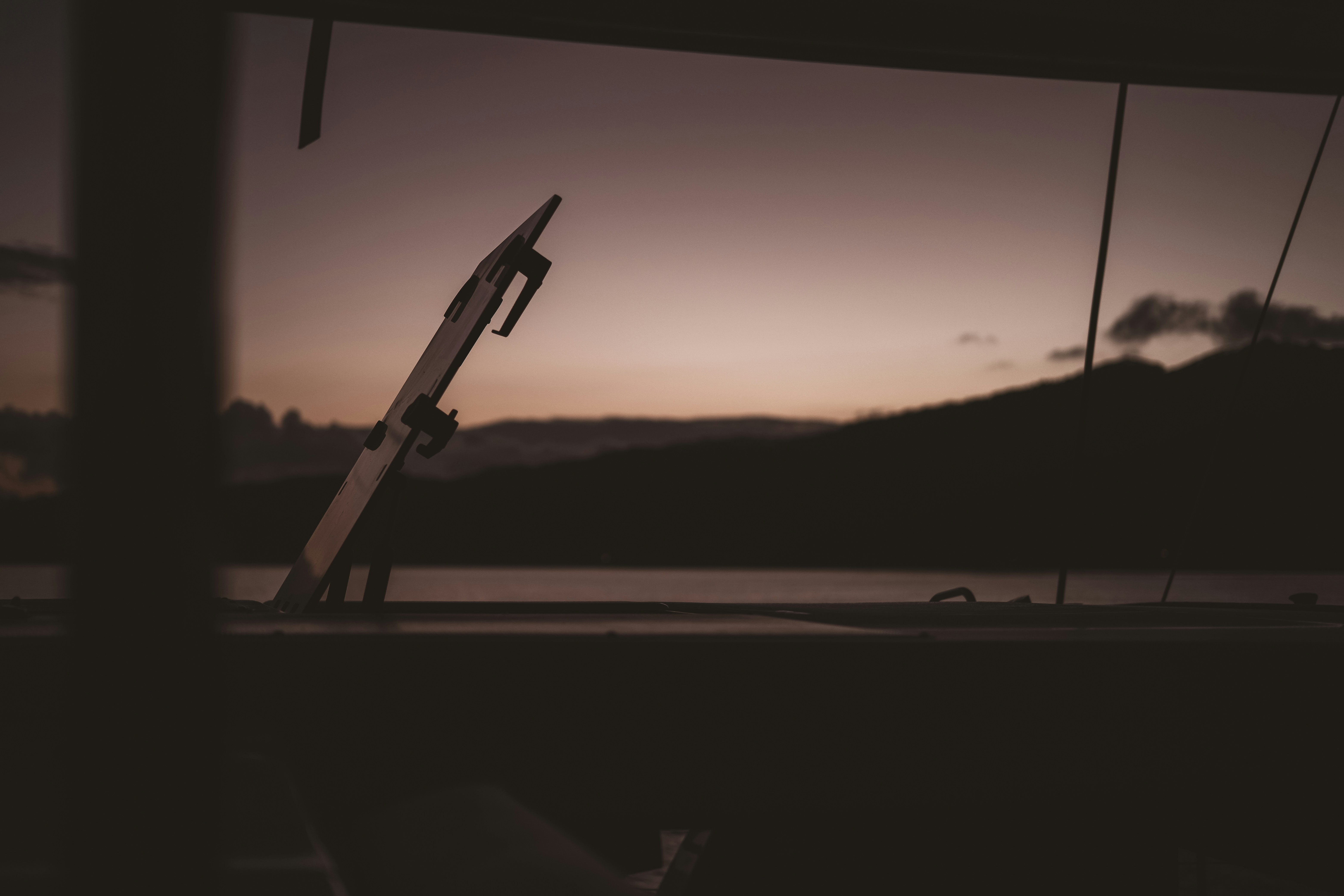 silhouette of a person on a hill during sunset